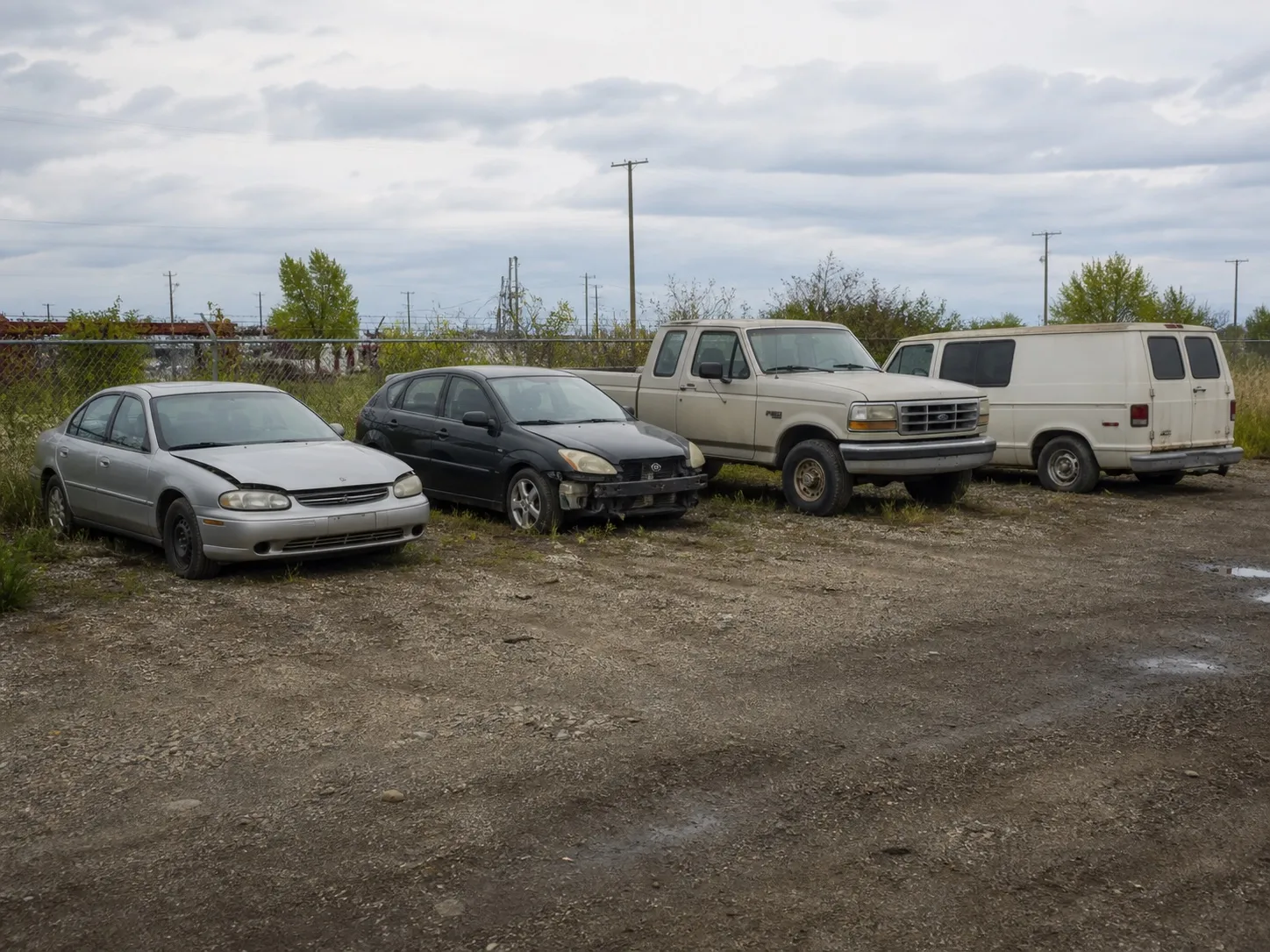 Older, non-running and damaged vehicles in ordinary everyday condition.